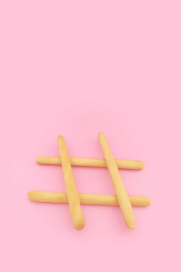 A mad of sticks, placed on a pink background